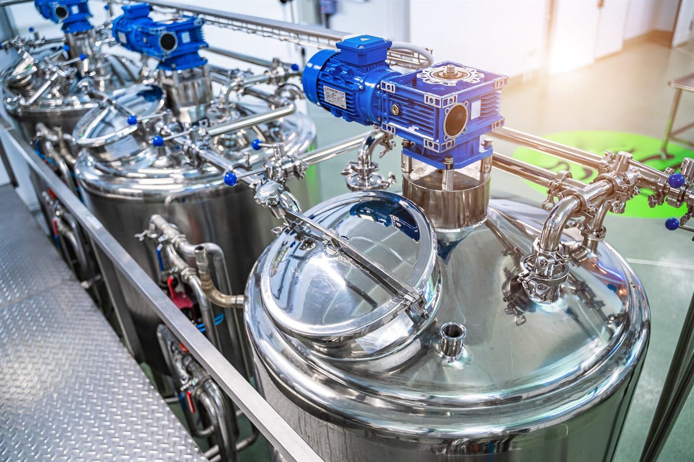 Stainless steel agitator tanks with blue motor gearboxes