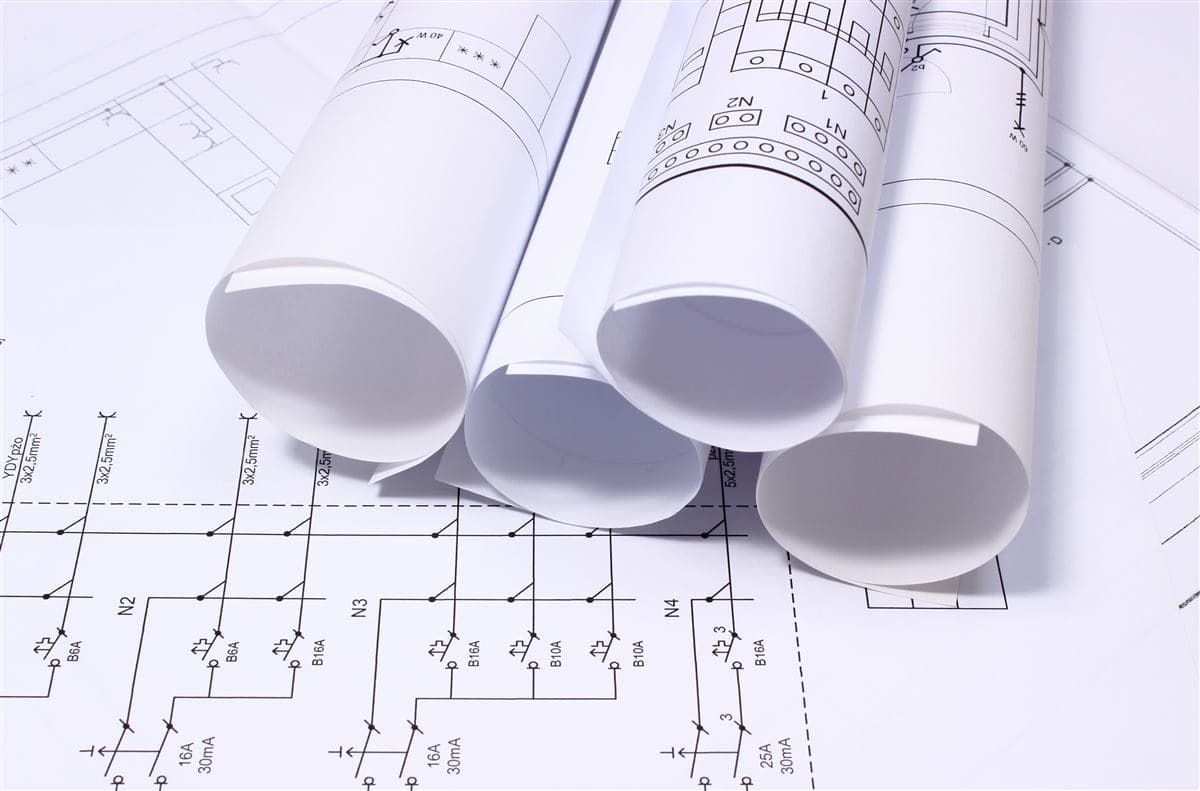 Rolled electrical control drawings on a schematic plan